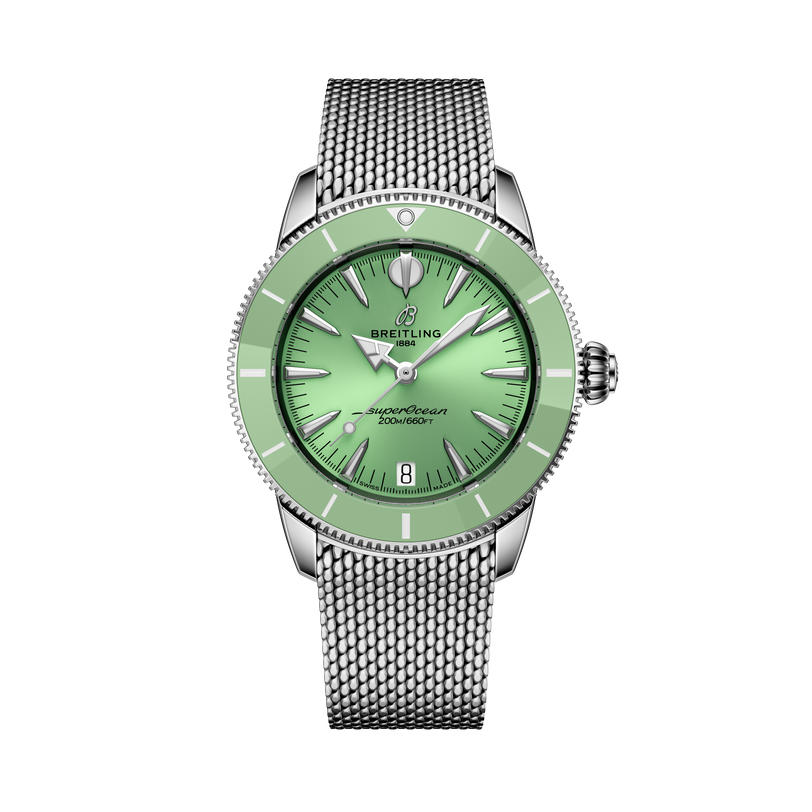 The Breitling Superocean Heritage Automatic 36 features a green dial and bezel, silver hour markers, and a silver mesh strap, showcased on a black background.